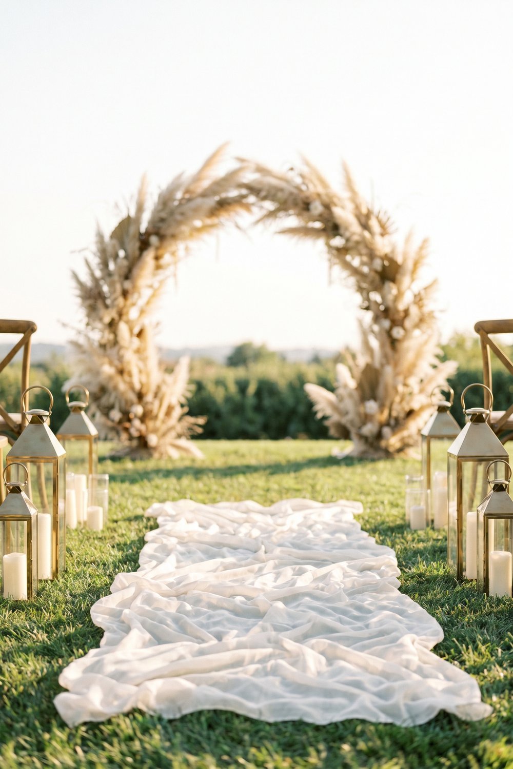 Wedding aisle decor with pampas and brass lanterns